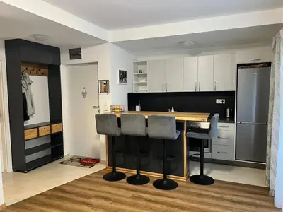 a kitchen with a wooden table and black bar stools at Winter Nights Vlasic in Vlasic