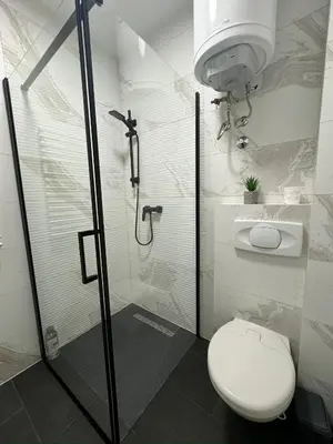 a bathroom with a shower with a toilet and a sink at Winter Nights Vlasic in Vlasic