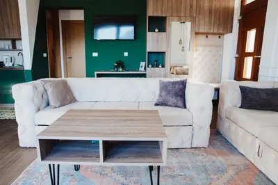 a living room with a white couch and a coffee table at Pine apartment Vlašić in Vlasic