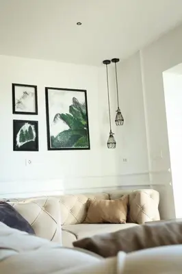 a living room with a couch and pictures on the wall at Pine apartment Vlašić in Vlasic