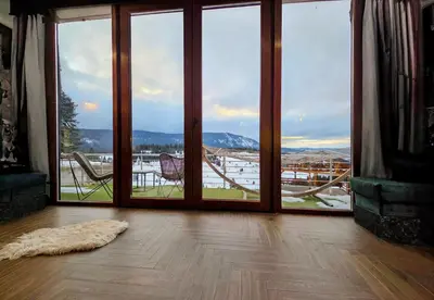 a room with a large glass door with a view at Pine apartment Vlašić in Vlasic