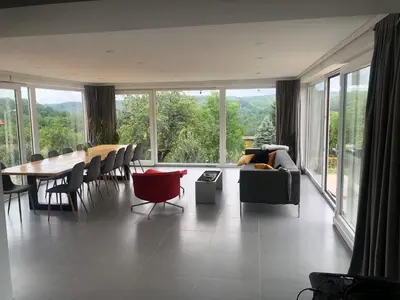 a living room with a couch and a table and chairs at Relax House in Banja Luka