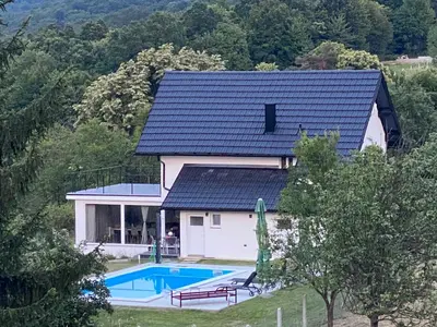 a house with a swimming pool in front of it at Relax House in Banja Luka