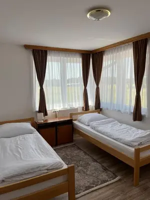 a bedroom with two beds and a window at Motel i Restoran Ana in Donji Svilaj
