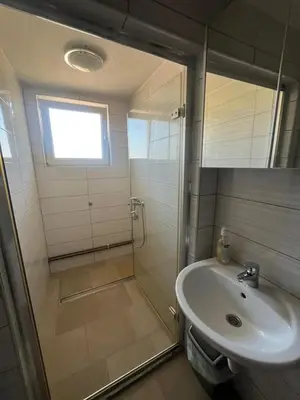 a bathroom with a shower and a sink at Motel i Restoran Ana in Donji Svilaj
