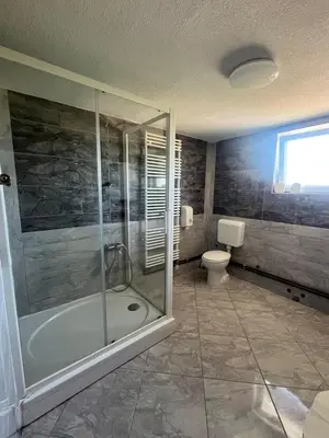 a bathroom with a shower and a toilet at Motel i Restoran Ana in Donji Svilaj