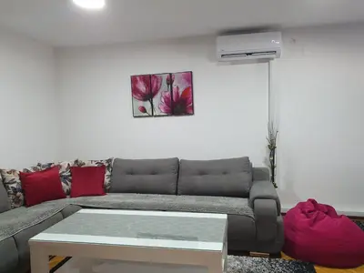 a living room with a couch and a table at Apartment Ema with garage in Velika Kladuša