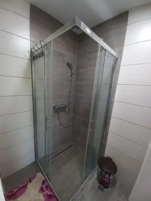 a shower with a glass door in a bathroom at Apartment Ema with garage in Velika Kladuša