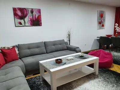 a living room with a couch and a table at Apartment Ema with garage in Velika Kladuša