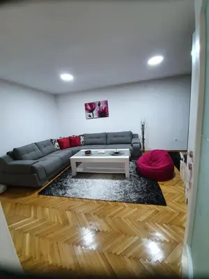 a living room with a couch and a coffee table at Apartment Ema with garage in Velika Kladuša