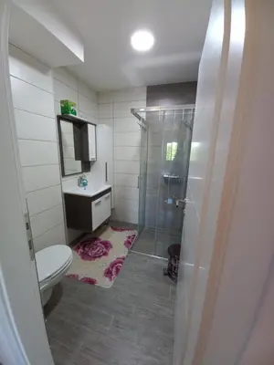a bathroom with a shower and a toilet and a sink at Apartment Ema with garage in Velika Kladuša
