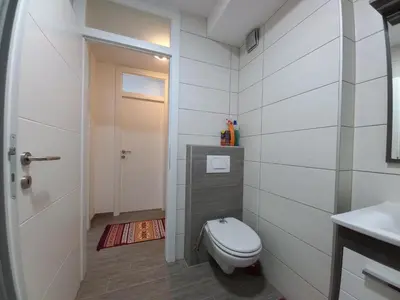 a bathroom with a toilet and a sink at Apartment Ema with garage in Velika Kladuša