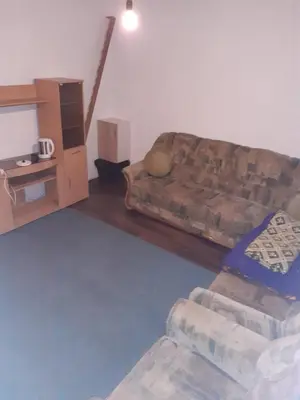 a living room with a couch and a table at Apartment 2KM from city center in Zenica