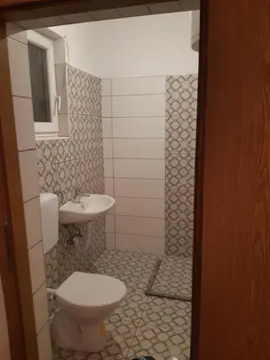 a bathroom with a toilet and a sink at Apartment 2KM from city center in Zenica