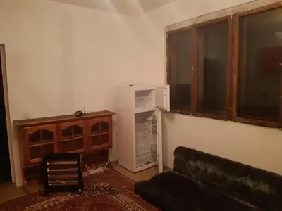 a living room with a couch and a refrigerator at Apartment 2KM from city center in Zenica