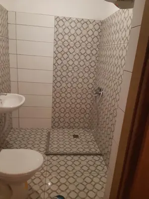 a bathroom with a shower with a toilet and a sink at Apartment 2KM from city center in Zenica