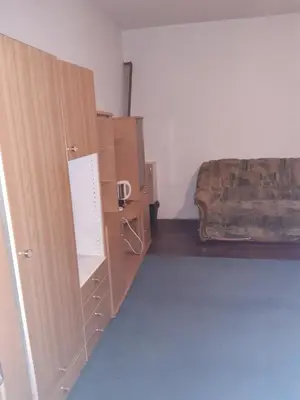 a bedroom with boxes and a bed in the corner at Apartment 2KM from city center in Zenica