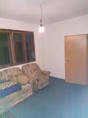 a living room with a couch and a window at Apartment 2KM from city center in Zenica