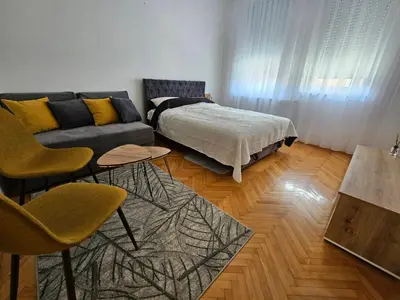 a living room with a couch and a bed at Stan na dan G & V in Prijedor