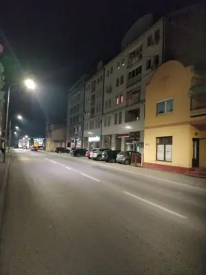 a city street at night with a street light and buildings at Stan na dan G & V in Prijedor