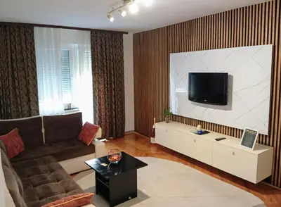 a living room with a couch and a flat screen tv at Dnevna Soba in Doboj