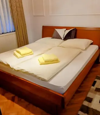 a bed with two yellow pillows on it at Dnevna Soba in Doboj