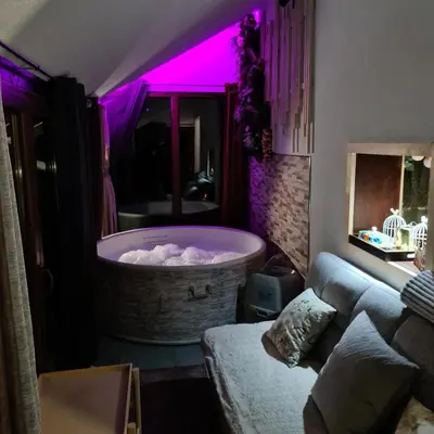 a living room with a large tub with purple lighting at Vikendica sa djakuzijem Borik in Grabova Kosa
