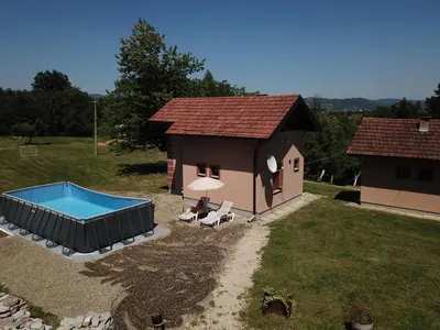 a small house with a swimming pool in the yard at Vikendica sa djakuzijem Borik in Grabova Kosa