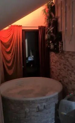 a large bath tub in a room with a window at Vikendica sa djakuzijem Borik in Grabova Kosa