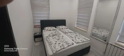 a small bed in a room with a window at STUDIO APARTMAN SOl in Tuzla