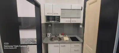 a small kitchen with a sink and a microwave at STUDIO APARTMAN SOl in Tuzla