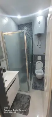 a bathroom with a toilet and a shower and a sink at STUDIO APARTMAN SOl in Tuzla