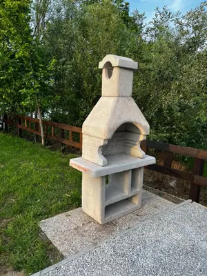 a stone oven sitting next to a wooden fence at Una, Home on river bank in Spilja