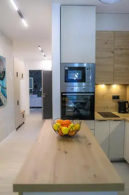 a bowl of fruit on a wooden table in a kitchen at Fancy new 2bdrm ap free garage in Banja Luka