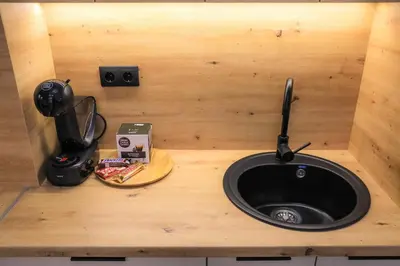 a counter with a sink in a wooden box at Fancy new 2bdrm ap free garage in Banja Luka