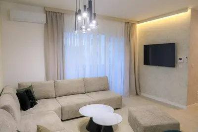 a living room with a couch and a tv at Fancy new 2bdrm ap free garage in Banja Luka