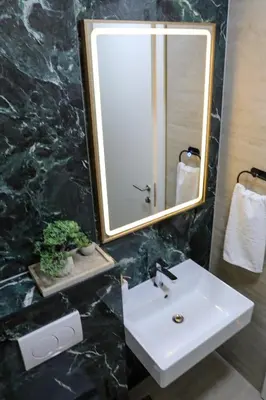 a bathroom with a sink and a mirror at Fancy new 2bdrm ap free garage in Banja Luka