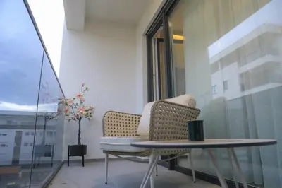 a room with a chair and a table and a window at Fancy new 2bdrm ap free garage in Banja Luka
