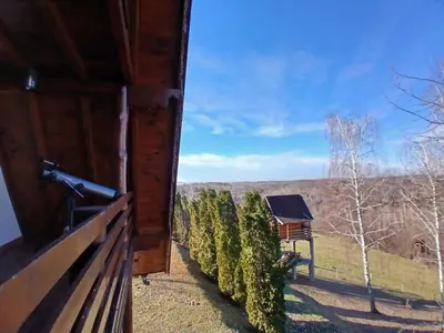 a view from the porch of a cabin with trees at Forest house ALEKSANDAR in Srbac