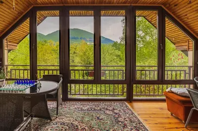 a living room with a view of the mountains at The Hide Aside in Plješevica