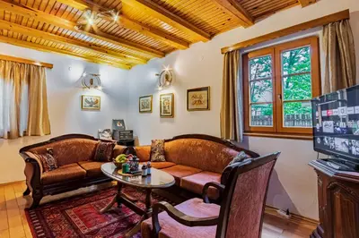 a living room with two leather couches and a table at The Hide Aside in Plješevica