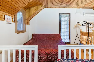 a bedroom with a red bed in a room at The Hide Aside in Plješevica