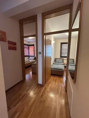 a living room with a mirror and a bedroom at Premium Apartment in Fojnica