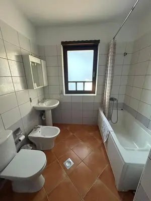 a bathroom with a toilet and a tub and a sink at Premium Apartment in Fojnica