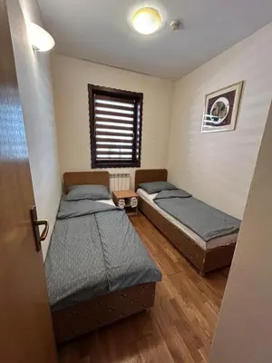 two beds in a room with a window at Premium Apartment in Fojnica
