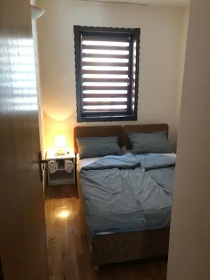 a small bedroom with a bed and a window at Premium Apartment in Fojnica