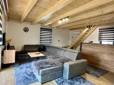 a living room with a couch and a table at Villa Pine in Lukavac