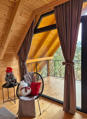 a room with a chair and a large window at Villa Pine in Lukavac