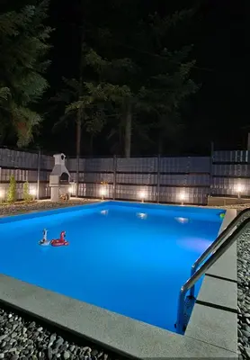 a large blue swimming pool with lights on it at Villa Pine in Lukavac