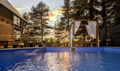 a lap pool with a shower and a chair in a backyard at Villa Pine in Lukavac